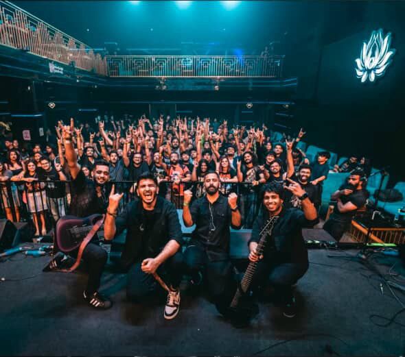 Energetic concert with performers and enthusiastic crowd